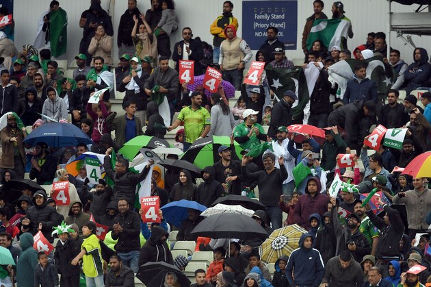 Pakistan fans celebrate a four in light rain during the ICC Champions trophy match between Pakistan and South Africa at Edgbaston in Birmingham on June 7, 2017. / AFP PHOTO / PAUL ELLIS / RESTRICTED TO EDITORIAL USE (Photo credit should read PAUL ELLIS/AFP/Getty Images) Pakistan fans celebrate a four in light rain during the ICC Champions trophy match between Pakistan and South Africa at Edgbaston in Birmingham on June 7, 2017. / AFP PHOTO / PAUL ELLIS / RESTRICTED TO EDITORIAL USE (Photo credit should read PAUL ELLIS/AFP/Getty Images)