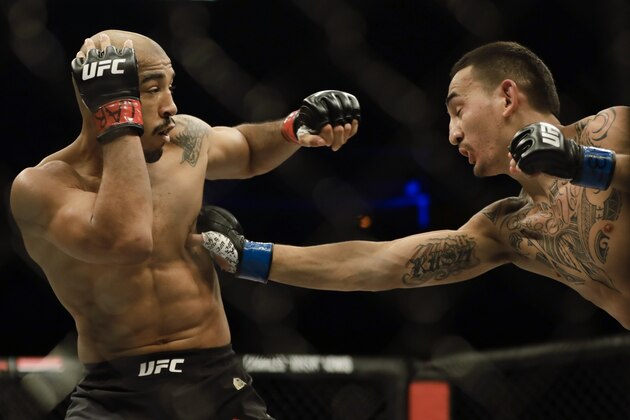 Jose Aldo, left, of Brazil, left, is hit by Max Holloway, of the United States, during their UFC featherweight mixed martial arts bout in Rio de Janeiro, Brazil, early Sunday, June 4, 2017. (AP Photo/Leo Correa) Jose Aldo, left, of Brazil, left, is hit by Max Holloway, of the United States, during their UFC featherweight mixed martial arts bout in Rio de Janeiro, Brazil, early Sunday, June 4, 2017. (AP Photo/Leo Correa)