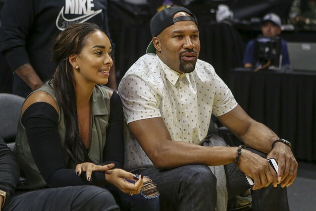 Former NBA player Derek Fisher and Gloria Govan watch the Game 2 of a WBNA basketball semifinal between Los Angeles Lakers and Chicago Sky in Los Angeles, Friday, Sept. 30, 2016. The Sparks won 99-84.  (AP Photo/Ringo H.W. Chiu)