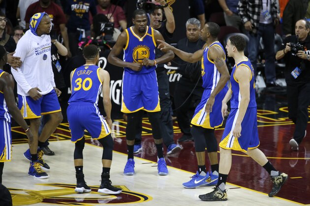 Golden State Warriors forward Kevin Durant (35) celebrates with teammates after the Warriors defeated the Cleveland Cavaliers 118-113 in Game 3 of basketball's NBA Finals in Cleveland, Wednesday, June 7, 2017. (AP Photo/Ron Schwane)