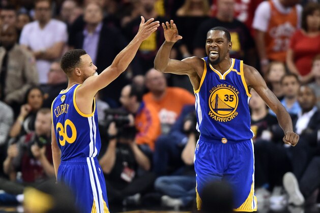 Jun 7, 2017; Cleveland, OH, USA; Golden State Warriors guard Stephen Curry (30) and forward Kevin Durant (35) celebrate during the fourth quarter against the Cleveland Cavaliers in game three of the 2017 NBA Finals at Quicken Loans Arena. Mandatory Credit: Ken Blaze-USA TODAY Sports