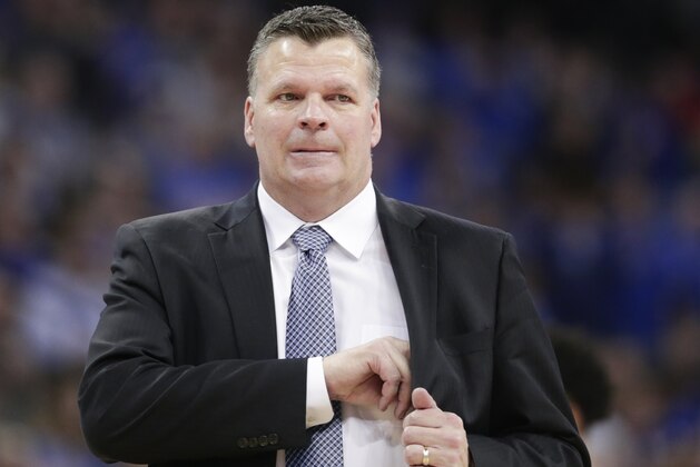 Creighton coach Greg McDermott reaches for his notes during the first half of an NCAA college basketball game against Georgetown in Omaha, Neb., Sunday, Feb. 19, 2017. (AP Photo/Nati Harnik)