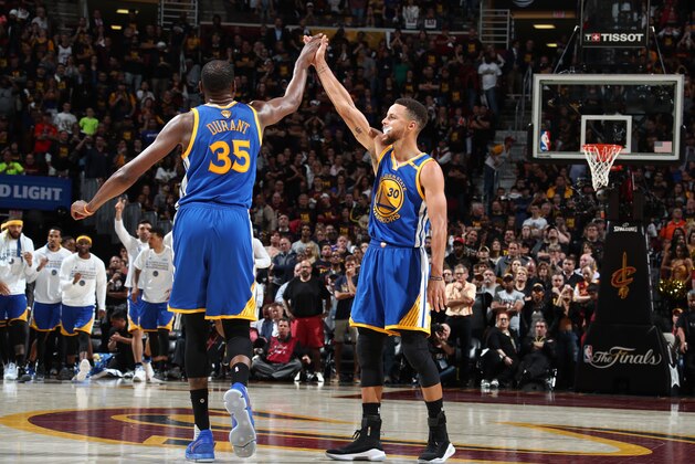 CLEVELAND, OH - JUNE 7:  Stephen Curry #30 of the Golden State Warriors high fives Kevin Durant #35 during the game against the Cleveland Cavaliers in Game Three of the 2017 NBA Finals on June 7, 2017 at Quicken Loans Arena in Cleveland, Ohio. NOTE TO USER: User expressly acknowledges and agrees that, by downloading and or using this photograph, user is consenting to the terms and conditions of Getty Images License Agreement. Mandatory Copyright Notice: Copyright 2017 NBAE (Photo by Nathaniel S. Butler/NBAE via Getty Images)