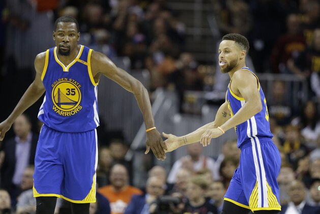 Golden State Warriors forward Kevin Durant (35) and Stephen Curry (30) play against the Cleveland Cavaliers during the second half of Game 3 of basketball's NBA Finals in Cleveland, Wednesday, June 7, 2017. (AP Photo/Tony Dejak)