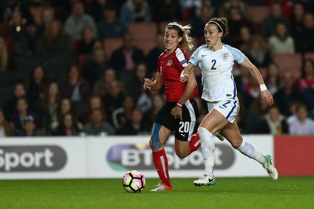 MILTON KEYNES, ENGLAND - APRIL 10:  Lucy Bronze of England Women moves forward with the ball watched by Lisa Makas of Austria Women during the International Friendly match between England Women and Austria Women at Stadium mk on April 10, 2017 in Milton Keynes, England.  (Photo by Pete Norton/Getty Images )