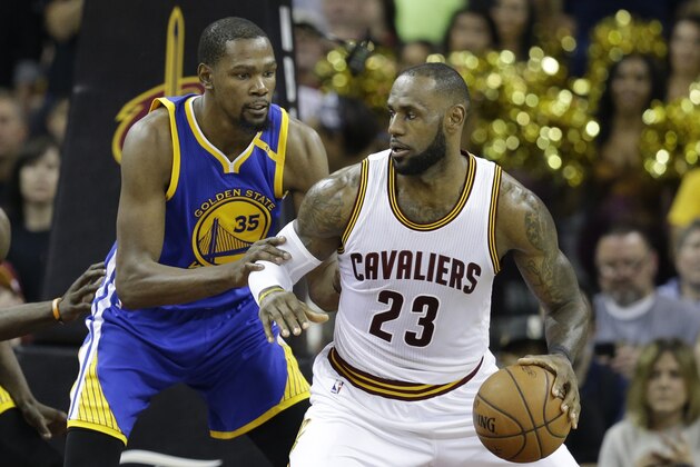 Golden State Warriors forward Kevin Durant (35) defends Cleveland Cavaliers forward LeBron James (23) during the second half of Game 3 of basketball's NBA Finals in Cleveland, Wednesday, June 7, 2017. (AP Photo/Tony Dejak)