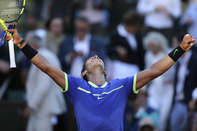 Spain's Rafael Nadal raises his arms on victory after defeating Austria's Dominic Thiem during their semifinal match of the French Open tennis tournament at the Roland Garros stadium, Friday, June 9, 2017 in Paris. Nadal won 6-3, 6-4, 6-0. (AP Photo/David Vincent)