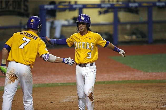 LSU's Kramer Robertson (3) is greeted at the plate by Greg Deichmann (7) after scoring on a sacrifice fly by Antoine Duplantis in the third inning of an NCAA college baseball tournament regional game against Rice in Baton Rouge, La., Sunday, June 4, 2017. (AP Photo/Gerald Herbert)