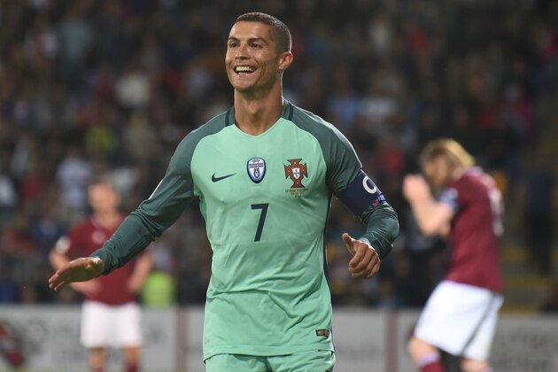 Portugal's forward Cristiano Ronaldo celebrate scoring during the FIFA World Cup 2018 qualification football match between Latvia and Portugal in Riga, on June 9, 2017. / AFP PHOTO / Janek SKARZYNSKI        (Photo credit should read JANEK SKARZYNSKI/AFP/Getty Images)