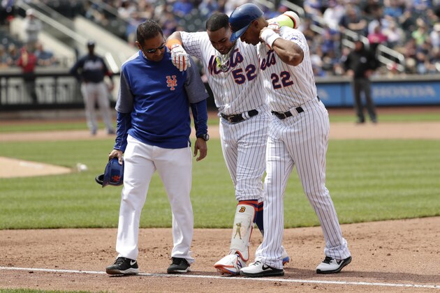 FILE - In this April 27, 2017, file photo, New York Mets' Yoenis Cespedes (52) is helped off the field by first base coach Tom Goodwin (22) and a trainer during the fourth inning of a baseball game against the Atlanta Braves in New York. New York has a number of key players on the disabled list, including outfielder Cespedes. (AP Photo/Frank Franklin II, File)