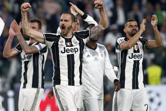 FILE - In this Tuesday, May 9, 2017 file photo, Juventus' Leonardo Bonucci, front, celebrates after the Champions League semi final second leg soccer match between Juventus and Monaco in Turin, Italy.  Juventus defeated Monaco by 2-1.  Juventus keeps on breaking records. And it set another one on Sunday when it clinched an unprecedented sixth successive Serie A title, with one game to spare, following a victory over Crotone. It is the first time since Serie A was founded in 1929 that a club has won six straight titles. (AP Photo/Antonio Calanni, File)