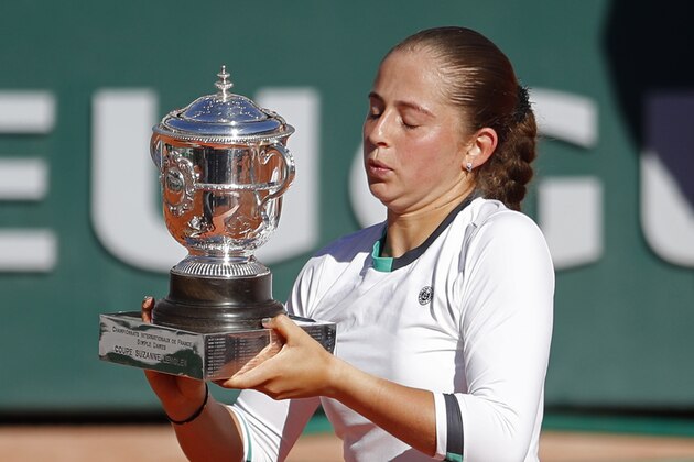 Latvia's Jelena Ostapenko holds the trophy after winning the women's final match of the French Open tennis tournament against Romania's Simona Halep in three sets 4-6, 6-4, 6-3, at the Roland Garros stadium, in Paris, France, Saturday, June 10, 2017. (AP Photo/Petr David Josek)