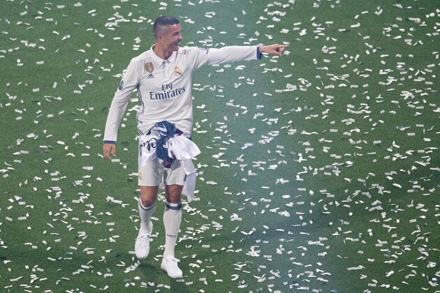 Real Madrid's Portuguese forward Cristiano Ronaldo points during a celebration event held at the Santiago Bernabeu stadium after the team won the the UEFA Champions League football match final Juventus vs Real Madrid CF held at the National Stadium of Wales in Cardiff on June 3, 2017. / AFP PHOTO / CURTO DE LA TORRE        (Photo credit should read CURTO DE LA TORRE/AFP/Getty Images)