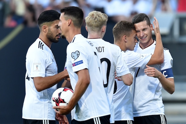 Germany's midfielder Julian Draxler (R) celebrates scoring the opening goal with his teammates (L-R) midfielder Emre Can,  midfielder Sandro Wagner, midfielder Julian Brandt and  defender Joshua Kimmich during the FIFA World Cup 2018 qualification football match between Germany and San Marino in Nuremberg, southern Germany, on June 10, 2017. / AFP PHOTO / Christof STACHE        (Photo credit should read CHRISTOF STACHE/AFP/Getty Images)