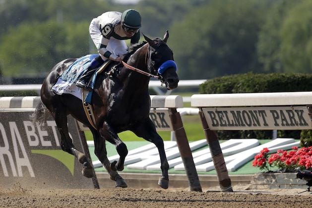 Jockey Mike Smith, riding Mor Spirit, crosses the finish line to win The Mohegan Sun Metropolitan, his fifth win of the day, at Belmont Park on Saturday, June 10, 2017, in Elmont, N.Y. (AP Photo/Peter Morgan)