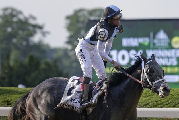 Jose Ortiz rises from his saddle after riding Tapwrit to victory in the 149th running of the Belmont Stakes horse race, Saturday, June 10, 2017, in Elmont, N.Y. (AP Photo/Peter Morgan)