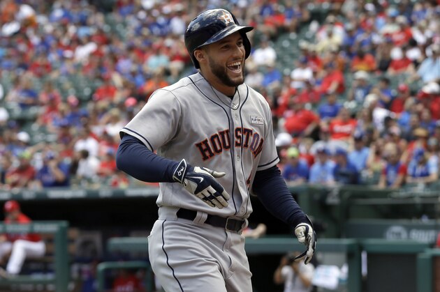 Houston Astros' George Springer celebrates his solo home run after crossing the plate in the first inning of a baseball game against the Texas Rangers on Sunday, June 4, 2017, in Arlington, Texas. (AP Photo/Tony Gutierrez)