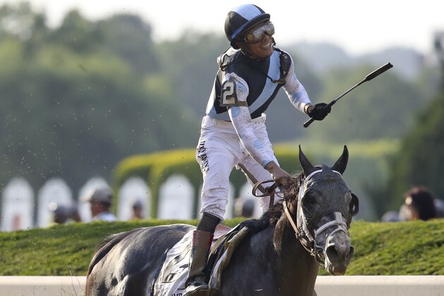 Jose Ortiz celebrates after riding Tapwrit to victory in the 149th running of the Belmont Stakes horse race, Saturday, June 10, 2017, in Elmont, N.Y. (AP Photo/Mary Altaffer)
