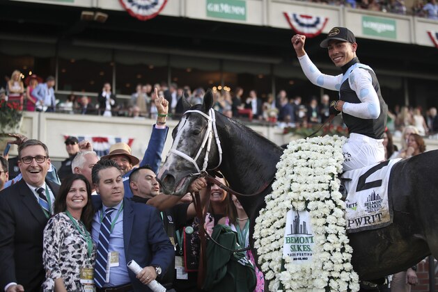 Jose Ortiz celebrates after riding Tapwrit to victory in the 149th running of the Belmont Stakes horse race, Saturday, June 10, 2017, in Elmont, N.Y. (AP Photo/Julio Cortez)