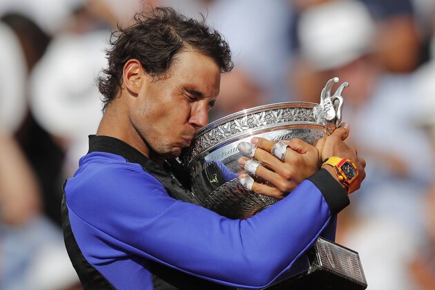 Spain's Rafael Nadal celebrates winning his tenth French Open title against Switzerland's Stan Wawrinka in three sets, 6-2, 6-3, 6-1, during their men's final match of the French Open tennis tournament at the Roland Garros stadium, in Paris, France, Sunday, June 11, 2017. (AP Photo/Christophe Ena)
