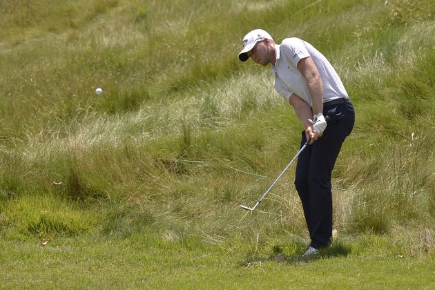 Daniel Berger hits from the edge of the rough on the first hole during the final round of the St. Jude Classic golf tournament Sunday, June 11, 2017, in Memphis, Tenn. (AP Photo/Brandon Dill)
