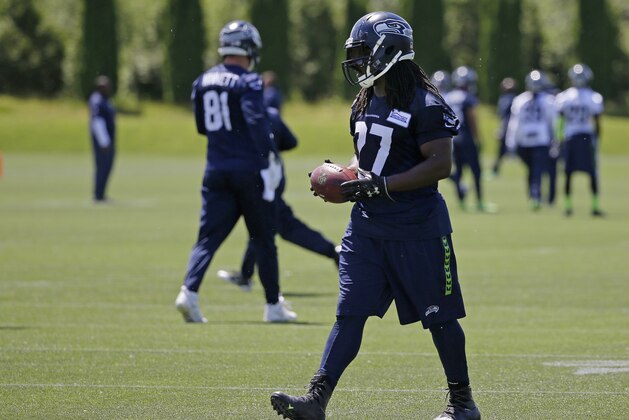 Seattle Seahawks running back Eddie Lacy walks with a football during NFL football practice, Friday, June 2, 2017, in Renton, Wash. (AP Photo/Ted S. Warren)