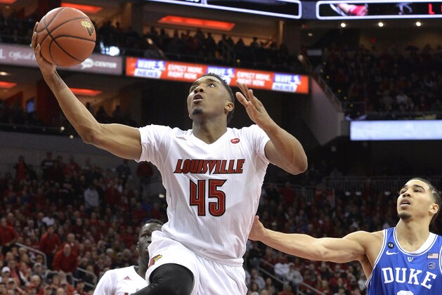 Louisville's Donovan Mitchell (45) goes in for a layup ahead of the defense of Duke's Jayson Tatum (0) during the second half of an NCAA college basketball game, Saturday, Jan. 14, 2017, in Louisville, Ky. Louisville won 78-69. (AP Photo/Timothy D. Easley)
