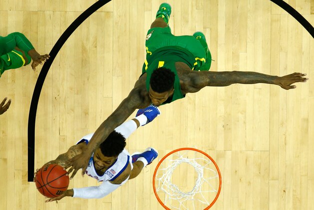 KANSAS CITY, MO - MARCH 25:  Frank Mason III #0 of the Kansas Jayhawks has his shot blocked by Jordan Bell #1 of the Oregon Ducks during the 2017 NCAA Men's Basketball Tournament Midwest Regional at Sprint Center on March 25, 2017 in Kansas City, Missouri.  (Photo by Jamie Squire/Getty Images)