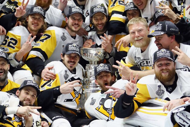 NASHVILLE, TN - JUNE 11:  The Pittsburgh Penguins pose for a group photo with the Stanley Cup Trophy after they defeated the Nashville Predators 2-0 in Game Six of the 2017 NHL Stanley Cup Final at the Bridgestone Arena on June 11, 2017 in Nashville, Tennessee.  (Photo by Bruce Bennett/Getty Images)