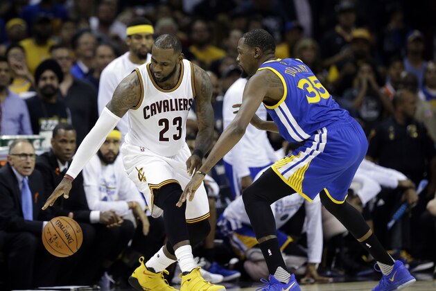 Golden State Warriors forward Kevin Durant (35) defends Cleveland Cavaliers forward LeBron James (23) in the second half of Game 4 of basketball's NBA Finals in Cleveland, Friday, June 9, 2017. (AP Photo/Tony Dejak)
