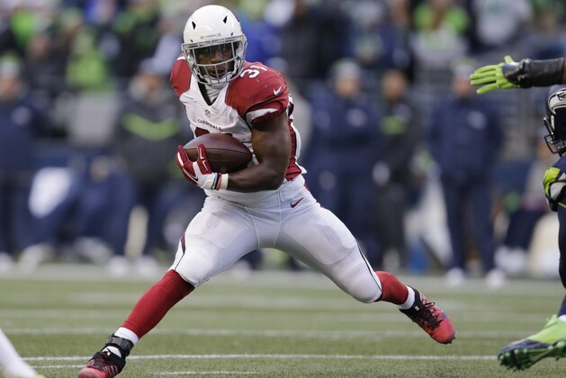 FILE - In this Dec. 24, 2016, file photo, Arizona Cardinals' David Johnson carries the ball against the Seattle Seahawks in the second half of an NFL football game, in Seattle. Maybe it's his cheerful smile or his squeeky clean character. Or his devastatingly athletic performances on the field. All these things have helped Arizona Cardinals running back David Johnson top the latest ``Rising 50'' list of players likely to break out and rank among next season's best sellers of licensed merachandise. (AP Photo/John Froschauer, File)