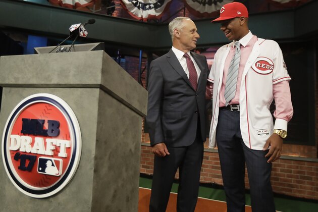 Hunter Greene, right, a pitcher and shortstop from Notre Dame High School in Sherman Oaks, Calif., talks to commissioner Rob Manfred after being selected No. 2 by the Cincinnati Reds in the first round of the Major League Baseball draft, Monday, June 12, 2017, in Secaucus, N.J.(AP Photo/Julio Cortez)