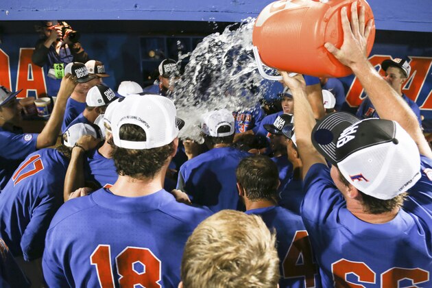 Florida players celebrate in the dugout after defeating Wake Forest 3-0 in an NCAA college super regional baseball game, Monday, June 12, 2017, in Gainesville, Fla. (AP Photo/Matt Stamey)