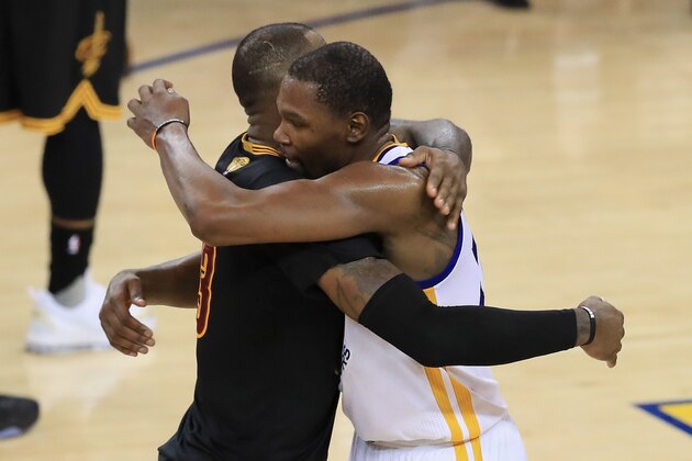 OAKLAND, CA - JUNE 12:  Kevin Durant #35 of the Golden State Warriors hugs LeBron James #23 of the Cleveland Cavaliers after defeating the Cleveland Cavaliers 129-120 in Game 5 to win the 2017 NBA Finals at ORACLE Arena on June 12, 2017 in Oakland, California. NOTE TO USER: User expressly acknowledges and agrees that, by downloading and or using this photograph, User is consenting to the terms and conditions of the Getty Images License Agreement.  (Photo by Ronald Martinez/Getty Images)