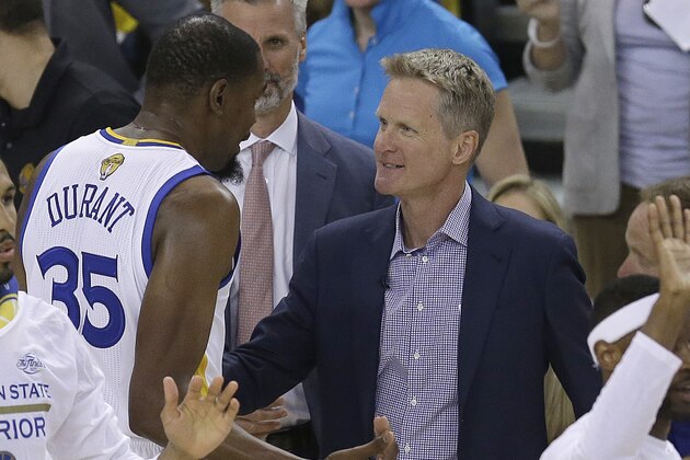 Golden State Warriors forward Kevin Durant (35) talks with head coach Steve Kerr during the first half of Game 2 of basketball's NBA Finals against the Cleveland Cavaliers in Oakland, Calif., Sunday, June 4, 2017. (AP Photo/Ben Margot)