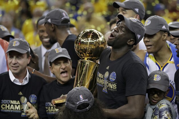 Golden State Warriors forward Draymond Green (23) holds the Larry O'Brien NBA Championship Trophy after Game 5 of basketball's NBA Finals against the Cleveland Cavaliers in Oakland, Calif., Monday, June 12, 2017. The Warriors won 129-120 to win the NBA championship. (AP Photo/Marcio Jose Sanchez)