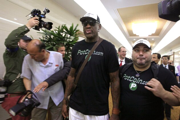 Former NBA basketball star Dennis Rodman, center,  arrives at Sunan International Airport on Tuesday, June 13, 2017, in Pyongyang, North Korea. Rodman has arrived in North Korea on his first visit since President Donald Trump took office. (AP Photo/Kim Kwang Hyon)