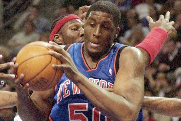 New York Knicks forward Michael Sweetney (50) pulls down a rebound in front of Detroit Pistons center Ben Wallace during the third quarter at the Palace in Auburn Hills, Mich., Tuesday, Feb. 22, 2005. (AP Photo/Carlos Osorio)