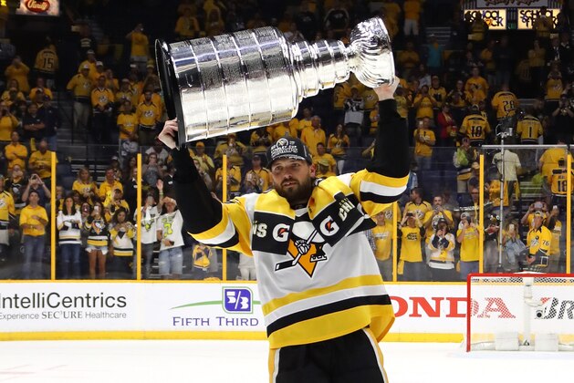 NASHVILLE, TN - JUNE 11:  Ron Hainsey #65 of the Pittsburgh Penguins celebrates with the Stanley Cup trophy after defeating the Nashville Predators 2-0 in Game Six of the 2017 NHL Stanley Cup Final at the Bridgestone Arena on June 11, 2017 in Nashville, Tennessee.  (Photo by Bruce Bennett/Getty Images)