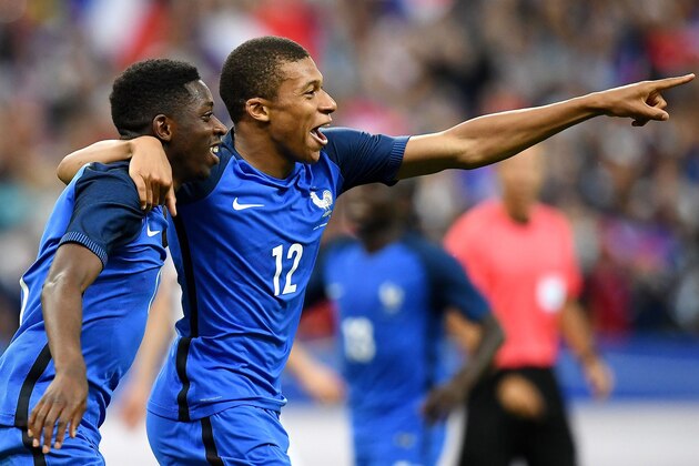 France's forward Ousmane Dembele (L) is congratulated by France's midfielder Kylian Mbappe following a goal during the international friendly football match between France and England at The Stade de France Stadium in Saint-Denis near Paris on June 13, 2017.                 / AFP PHOTO / FRANCK FIFE        (Photo credit should read FRANCK FIFE/AFP/Getty Images)