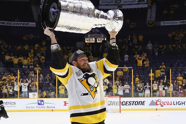NASHVILLE, TN - JUNE 11: Carter Rowney #37 of the Pittsburgh Penguins celebrates with the Stanley Cup trophy after defeating the Nashville Predators 2-0 in Game Six of the 2017 NHL Stanley Cup Final at the Bridgestone Arena on June 11, 2017 in Nashville, Tennessee.  (Photo by Bruce Bennett/Getty Images)