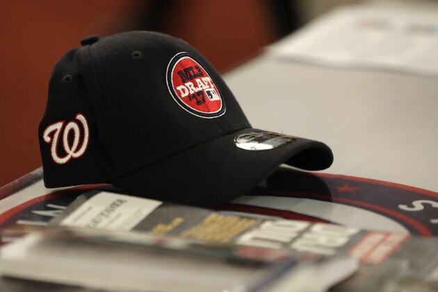 A Washington Nationals logo is seen on a cap with the Major League Baseball draft logo prior to the draft, Monday, June 12, 2017, in Secaucus, N.J.(AP Photo/Julio Cortez)