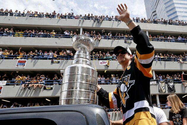 Pittsburgh Penguins' Sidney Crosby waves to the crowd while holding onto the Stanley Cup while riding along the victory parade route in Pittsburgh, Pa., Wednesday, June 15, 2016. The Penguins defeated the San Jose Sharks on Sunday to win the NHL hockey championship. (AP Photo/Keith Srakocic) Pittsburgh Penguins' Sidney Crosby waves to the crowd while holding onto the Stanley Cup while riding along the victory parade route in Pittsburgh, Pa., Wednesday, June 15, 2016. The Penguins defeated the San Jose Sharks on Sunday to win the NHL hockey championship. (AP Photo/Keith Srakocic)