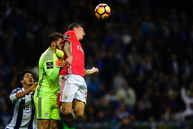 (FromR) Benfica's Swedish defender Victor Nilsson-Lindelof, teammate Brazilian goalkeeper Ederson Santana and Porto's midfielder Andre Silva jump for a ball during the Portuguese league football match FC Porto vs SL Benfica at the Dragao stadium in Porto on November 6, 2016.  / AFP / MIGUEL RIOPA        (Photo credit should read MIGUEL RIOPA/AFP/Getty Images)