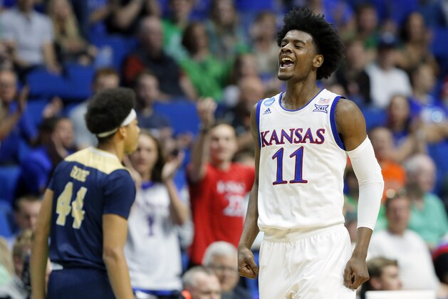 Kansas's Josh Jackson (11) celebrates a basket in front of UC Davis's Garrison Goode (44) in the first half of a first-round game in the men's NCAA college basketball tournament in Tulsa, Okla., Friday March 17, 2017. (AP Photo/Tony Gutierrez)