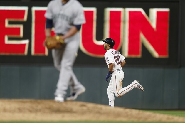 Minnesota Twins' Eddie Rosario hits a solo home run off Seattle Mariners catcher-turned-pitcher Carlos Ruiz in the eighth inning of a baseball game Tuesday, June 13, 2017, in Minneapolis. The Twins won 20-7. Rosario went 4-for-5 with three home runs and five RBI's. (AP Photo/Jim Mone)