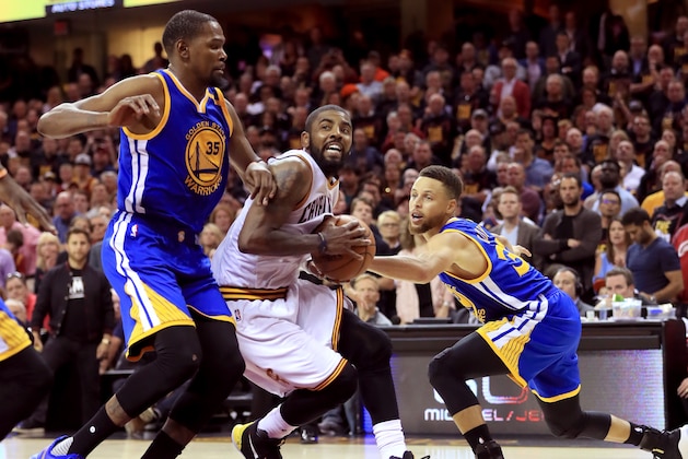 CLEVELAND, OH - JUNE 07: Kyrie Irving #2 of the Cleveland Cavaliers handles the ball against Kevin Durant #35 and Stephen Curry #30 of the Golden State Warriors in the second half in Game 3 of the 2017 NBA Finals at Quicken Loans Arena on June 7, 2017 in Cleveland, Ohio. NOTE TO USER: User expressly acknowledges and agrees that, by downloading and or using this photograph, User is consenting to the terms and conditions of the Getty Images License Agreement.  (Photo by Ronald Martinez/Getty Images)