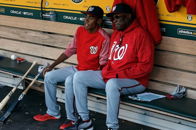 OAKLAND, CA - JUNE 02:  Dusty Baker #12 of the Washington Nationals sits with his son Darren Baker in the dugout before the game against the Oakland Athletics at the Oakland Coliseum on June 2, 2017 in Oakland, California. The Washington Nationals defeated the Oakland Athletics 13-3. (Photo by Jason O. Watson/Getty Images)