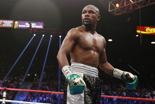 Floyd Mayweather Jr. looks at Andre Berto during their welterweight title boxing bout Saturday, Sept. 12, 2015, in Las Vegas. (AP Photo/John Locher)