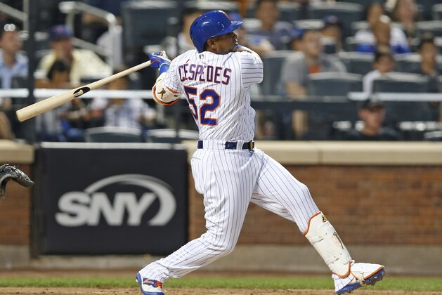 Yoenis Cespedes swings during a baseball game against the Chicago Cubs, Monday, June 12, 2017, in New York. The Mets won 6-1. Cespedes exited because of a sore left heel, two days after he returned from a six-week stint on the disabled list.  (AP Photo/Kathy Willens)